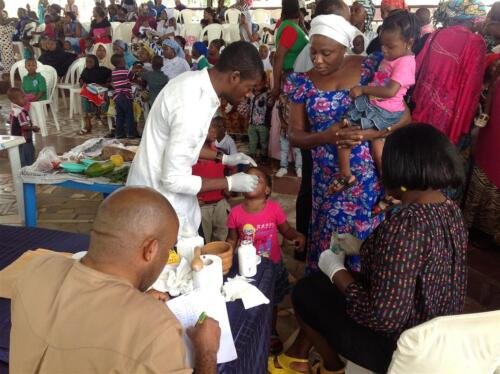 Health worker immunizing babies